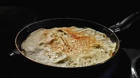 Accelerated pancake frying process. The batter is covered with a blush on the Stock Footage 264393507