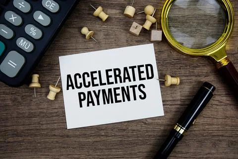 Accelerated Payments text written on notepad with pen, magnifying glass and.. Stock Photos