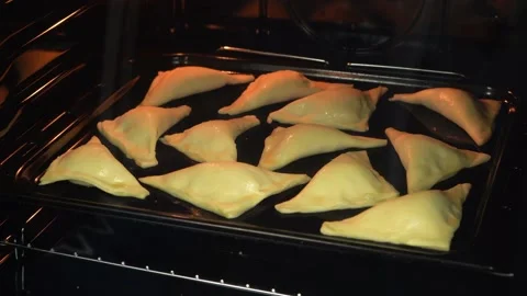 The accelerated process of baking buns puff pastry in the oven, close-up, 4K Stock Footage 132464610