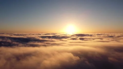 Accelerated recording, a time-lapse flight over the clouds early in the morning Stock Footage