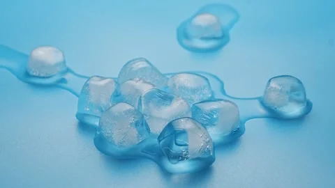 Accelerated shooting. The process of melting ice cubes on a blue background.  Stock Footage 289570578