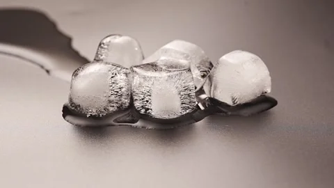 Accelerated shooting. The process of melting ice cubes on a black background.  Stock Footage 289570687