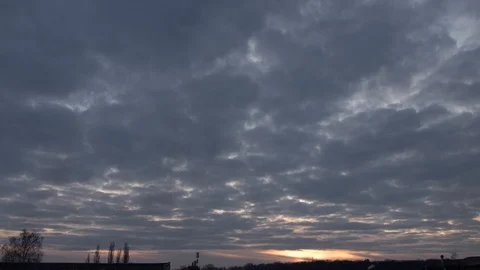 Accelerated sunset video. Gray clouds swim in the sunset. Timelapse Stock Footage 125156061