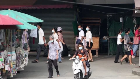 Accelerated video of traffic at a small intersection next to a market Stock Footage 240784209