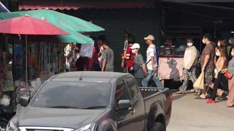 Accelerated video of traffic at a small intersection next to a market Stock Footage 255385243