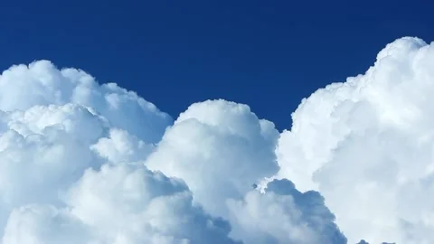 Accelerated video of white, fluffy clouds. Curly clouds merge into one. Video stock 156493661
