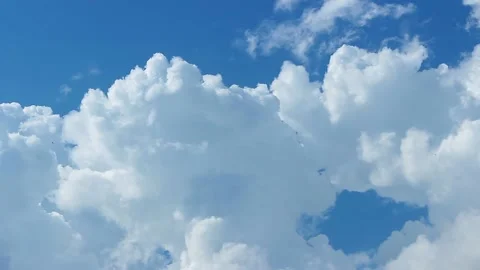 Accelerated video of white, fluffy clouds. Curly clouds merge into one. Stock Footage 156673374