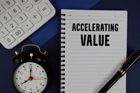 Accelerating Value text written on notepad with calculator and alarm clock .. Stock Photos