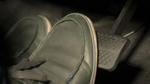 Accelerator and break pedal in a car. Close up the foot pressing Stock Footage 157578982