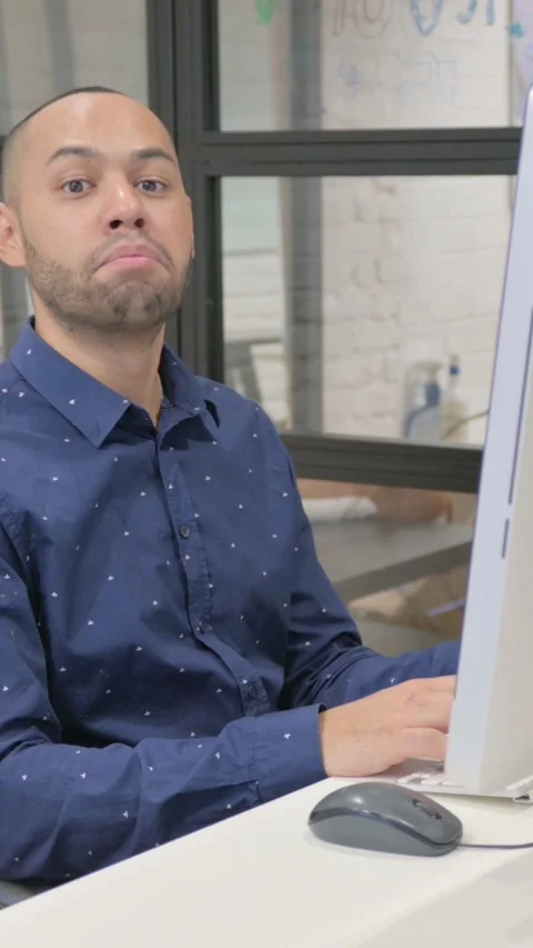 Accepting Hispanic Businessman Shaking Head in Approval while Using Desktop, Video stock 325701281