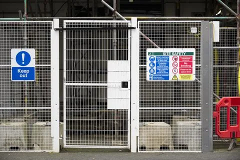 Access gate to construction site and health and safety message rules sign board Stock Photos