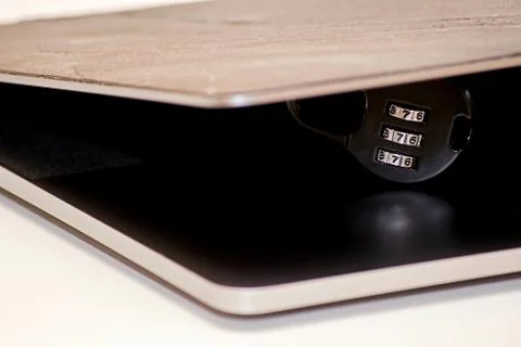 Access to a personal computer protected by a padlock with a code Stock Photos