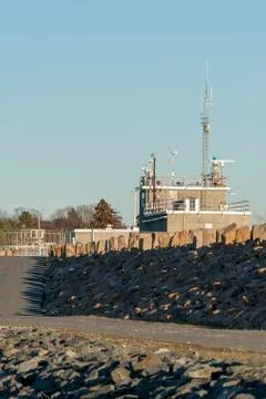Access road and walking path along hurricane barrier Stock Photos