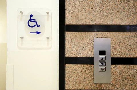 Accessible environment: sign-pointer lift for disabled wheelchair users Stock Photos