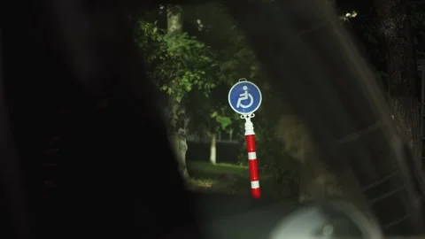 Accessible Parking Sign Viewed From Car Window at Night Stock Footage 343781951