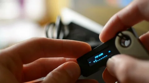 Accessing Ledger cold hardware Bitcoin cryptocurrency wallet by entering secure 库存影片 93944947