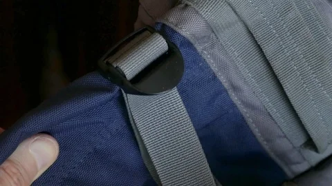 Accessories of backpack slings to reduce volume Stock Footage 73377372