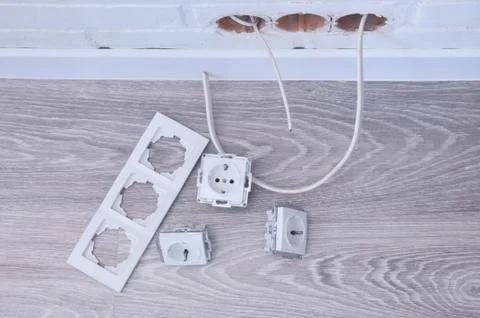 Accessories for the installation of sockets. Triple socket on the floor. Stock Photos