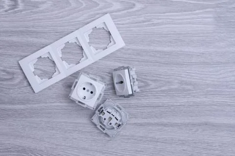 Accessories for the installation of sockets. Triple socket on the floor. Stock Photos