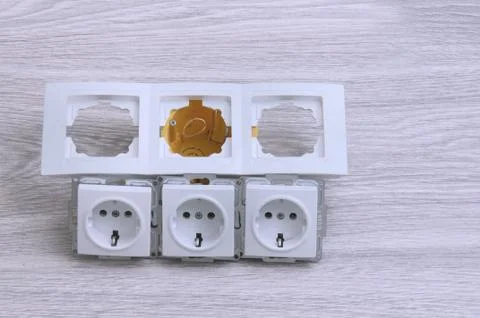 Accessories for the installation of sockets. Triple socket on the floor. Stock Photos