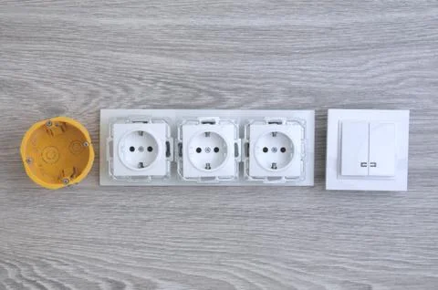 Accessories for the installation of sockets. Triple socket on the floor. Stock Photos
