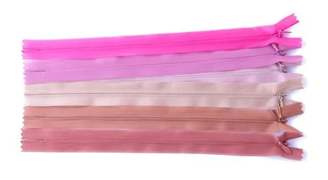 Accessories for sewing and needlework. Multi-colored zippers and snakes for s Stock Photos