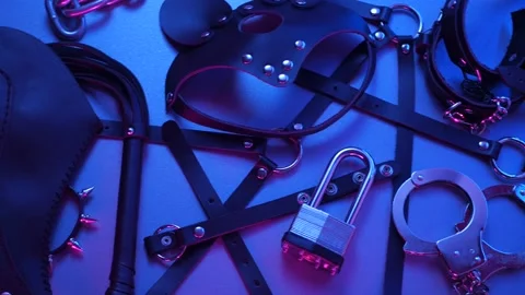 Accessory for BDSM games on a dark background in neon light Stock Footage 150203199