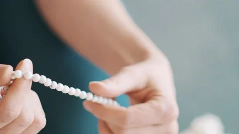An accessory for reading prayers or japas made of white gowlite stone. Handmade Stock Footage 130546333