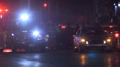 Accident at night in city intersection with ambulance and police at crash scene Stock Footage 82987579
