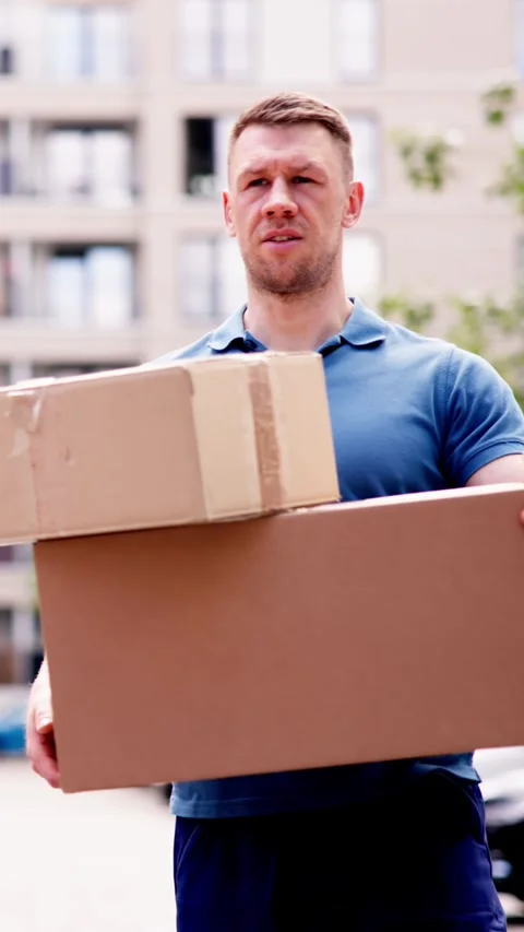 Accident-prone delivery man dropping a box on the street, causing damage 스톡 동영상 278698459