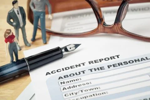 Accident report application form and pen on brown envelope and eyeglass, busi Stock-Fotos