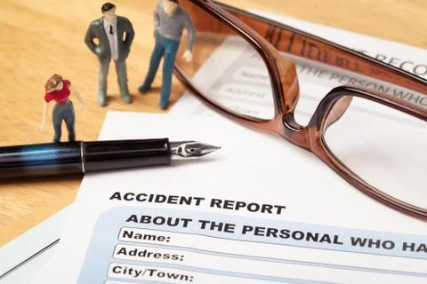 Accident report application form and pen on brown envelope and eyeglass, busi Stock Photos