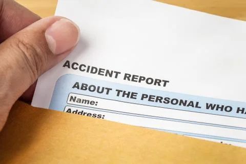 Accident report application form and human hand on brown envelope, business i Stock Photos