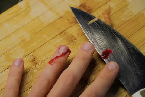 Accidental Finger Cut While Cooking in Kitchen Stock Photos
