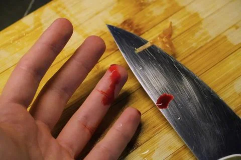 Accidental Finger Cut While Cooking in Kitchen Stock Photos