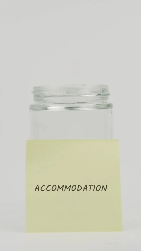 Accommodation text or word on yellow sticky note attached to glass jar Stock Footage 311675171