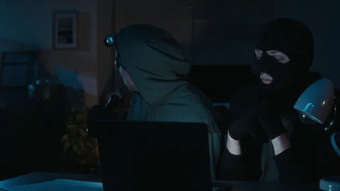 Accomplices Turning around to Look at Door Hacking Database Servers on Laptop Stock Footage 321681653