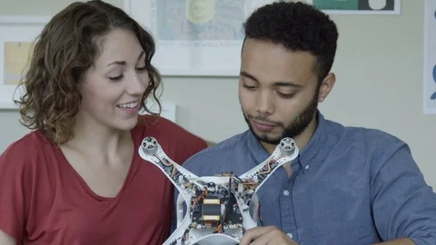 Accomplished young engineering students portrait with a robot. Видео 82408453