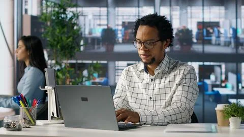 Account executive multitasking on his computer to finish business tasks Foto stock