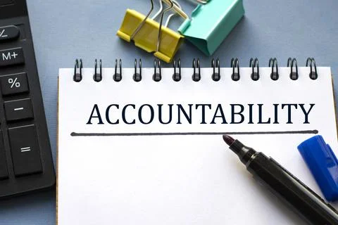 ACCOUNTABILITY word is written in a notebook with a marker, calculator, clamp Stock Photos