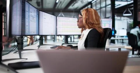 Accountant Analyzing Tax Codes On Computer Screen In Office Setting. Foto stock