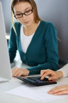 Accountant checking financial statement or counting by calculator income for tax Stock Photos