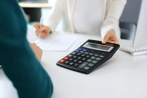 Accountant checking financial statement or counting by calculator income for tax Stock Photos