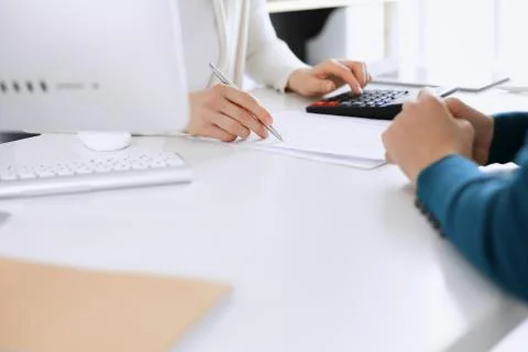 Accountant checking financial statement or counting by calculator income for tax Stock Photos