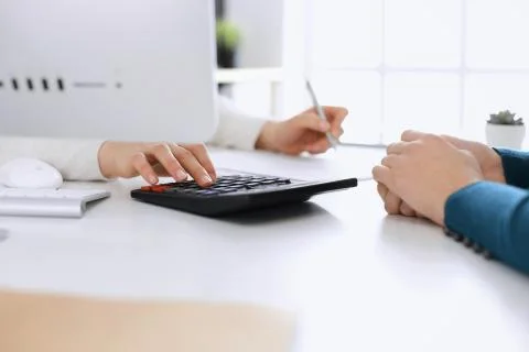 Accountant checking financial statement or counting by calculator income for tax Stock Photos