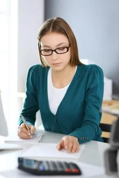 Accountant checking financial statement or counting by calculator income for tax Stock Photos