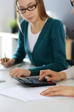 Accountant checking financial statement or counting by calculator income for tax Stock Photos