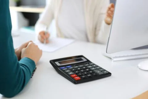Accountant checking financial statement or counting by calculator income for tax Stock Photos