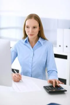 Accountant checking financial statement or counting by calculator income for tax Stock Photos