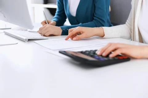 Accountant checking financial statement or counting by calculator income for tax Stock Photos